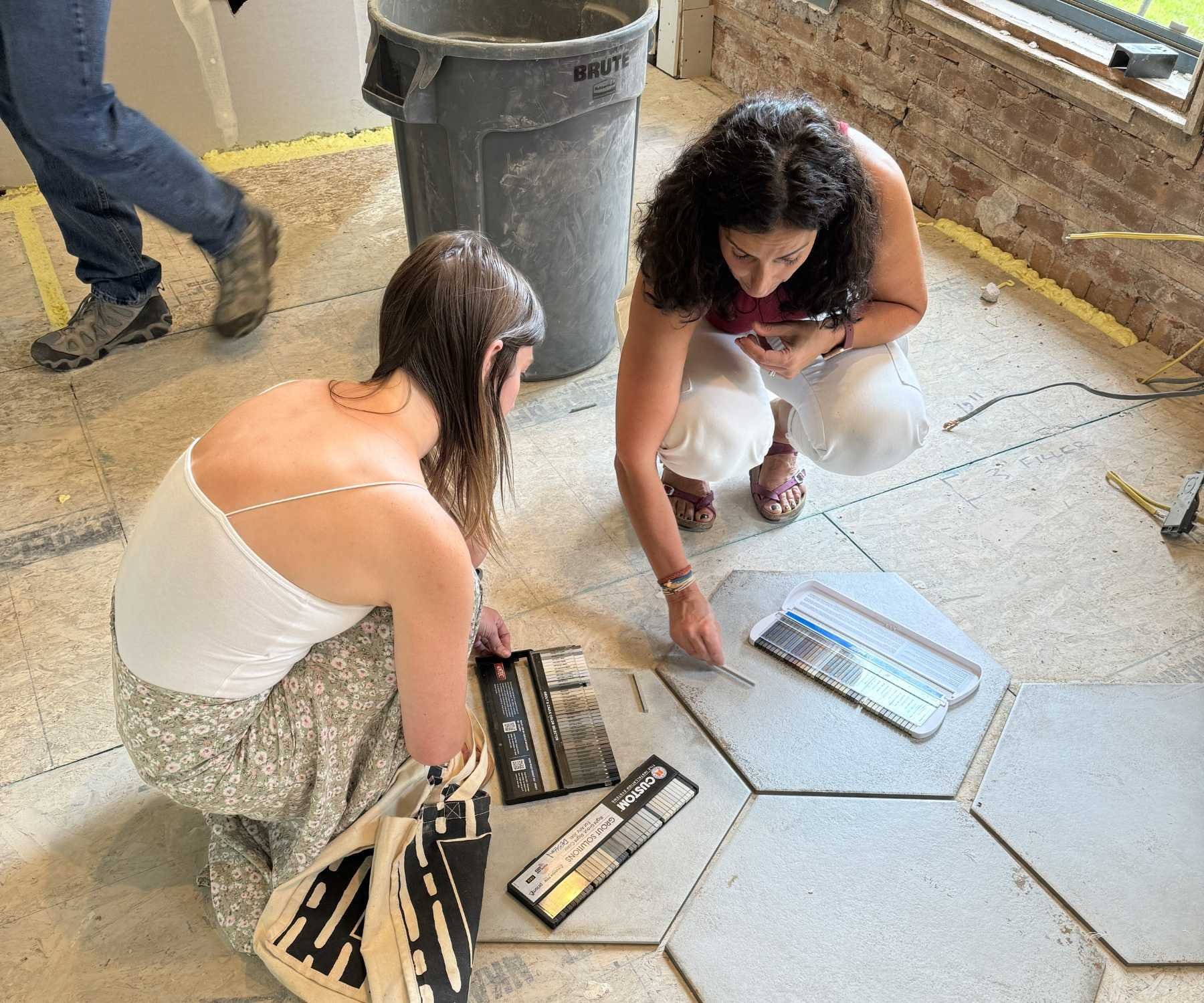 Image of Petra team members selecting tile finishes during a home remodel in Old Town Longmont, CO