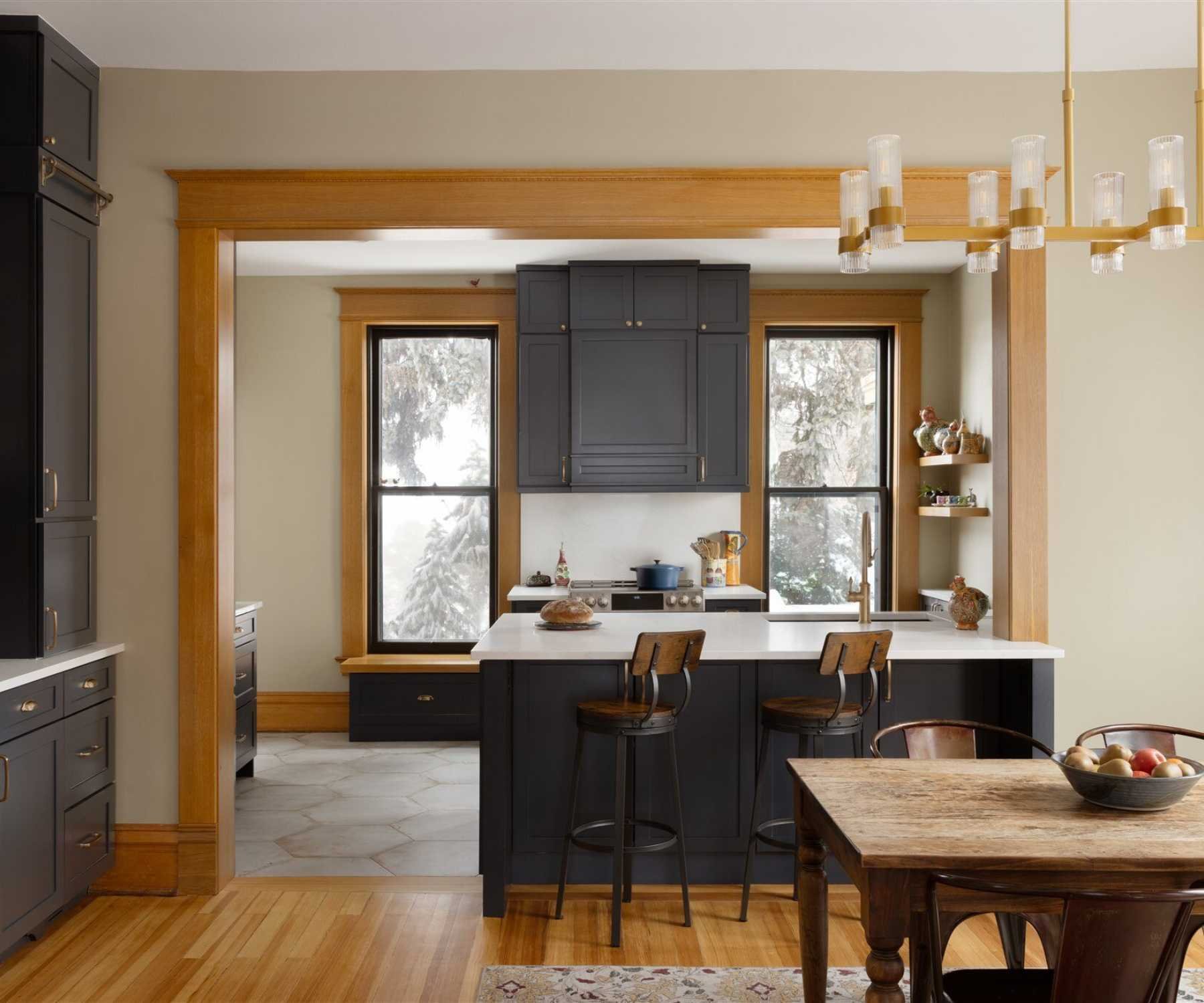 Image of custom kitchen remodel with black cabinetry and large island in Old Town Longmont, CO by Petra Custom Builders