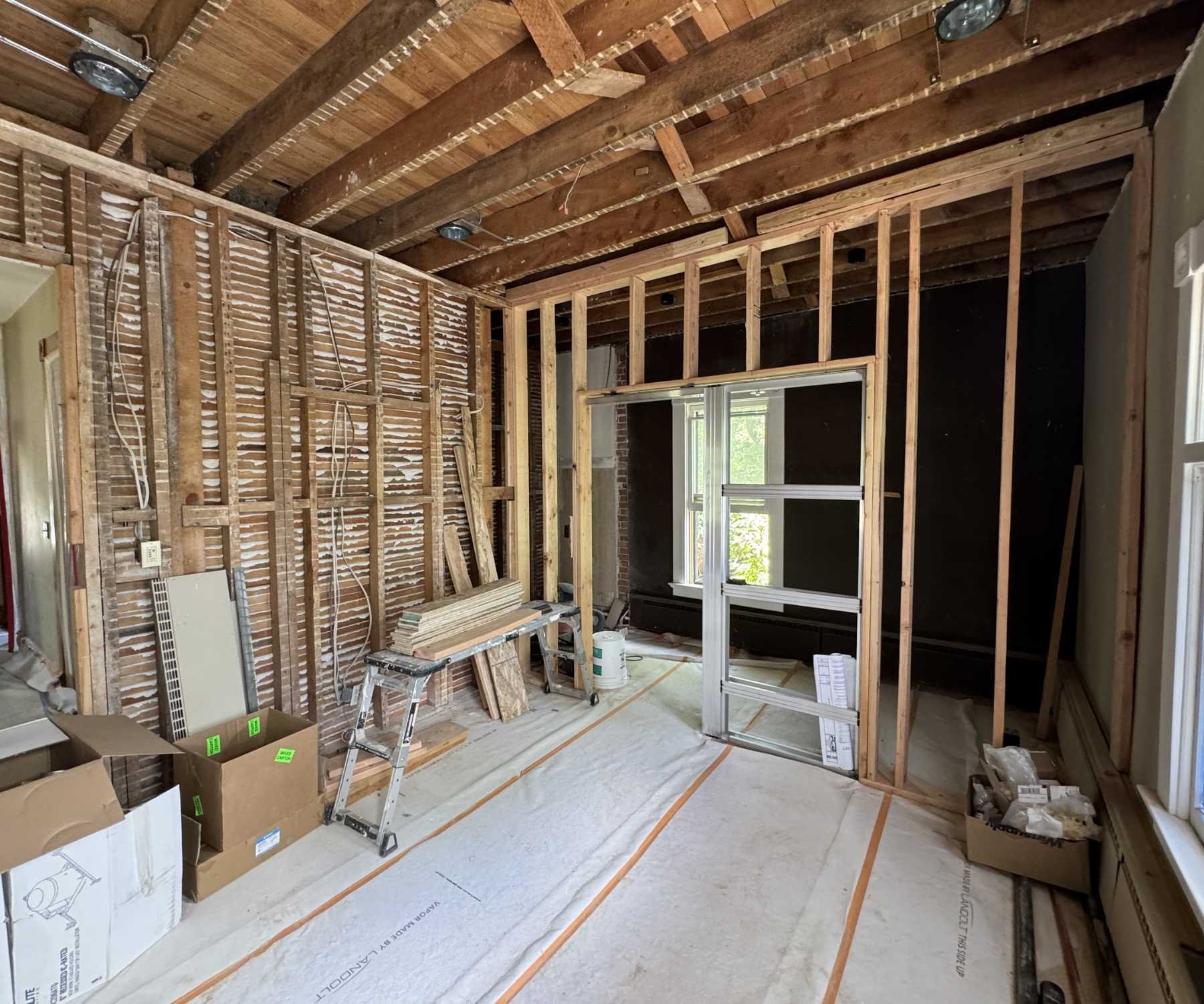 Photo of exposed beams and kitchen renovation framing in Old Town Longmont, CO by Petra Custom Builders Photo of exposed beams and kitchen renovation framing in Old Town Longmont, CO by Petra Custom Builders