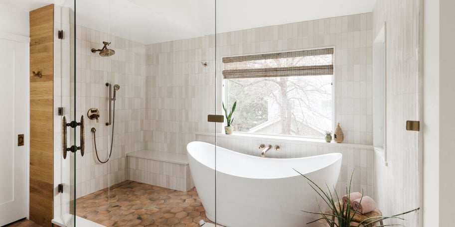 luxury bathroom remodel in Boulder Colorado featuring a freestanding white tub, a wet room with a frameless glass door, and custom tile finishes.