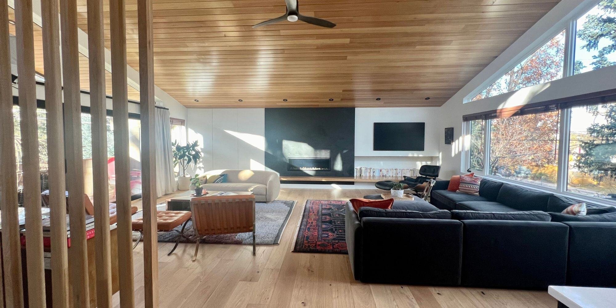 Spacious living room with slanted ceiling and natural light in a mid century modern style home remodel in boulder co
