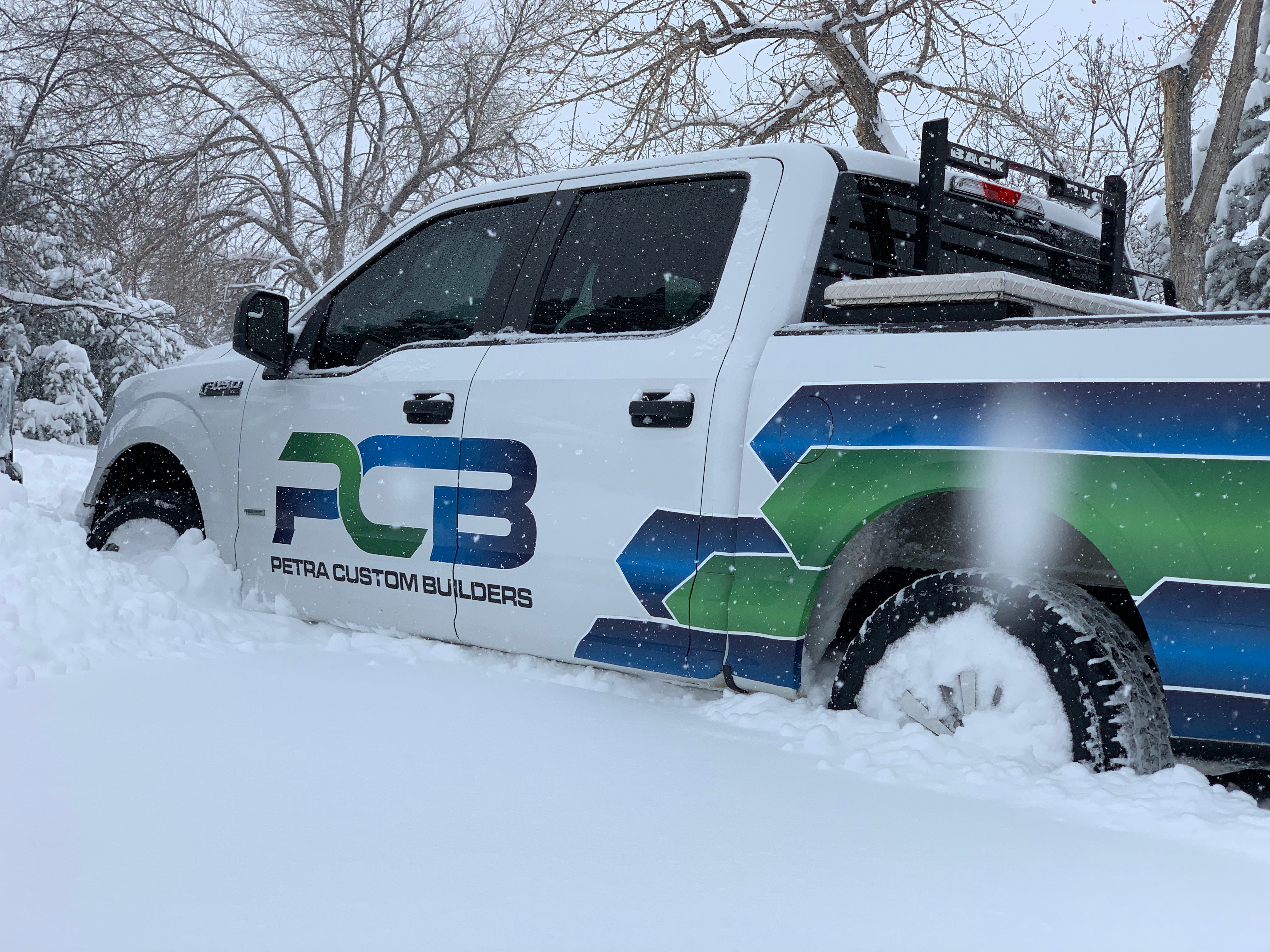 Petra Custom Builders truck in the snow