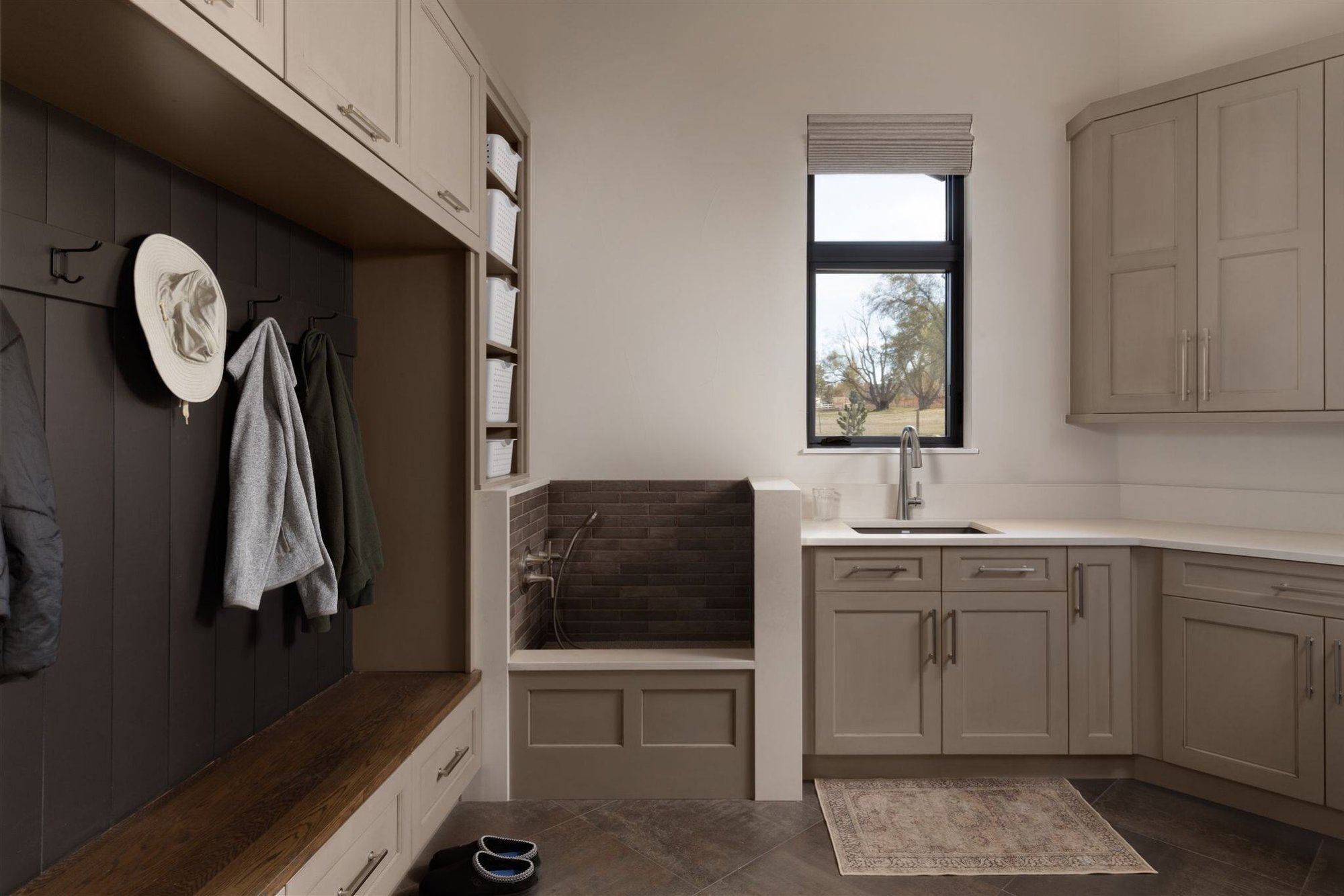 custom mudroom in a colorado home with taupe cabinets, dog washing station, and built in cabinetry