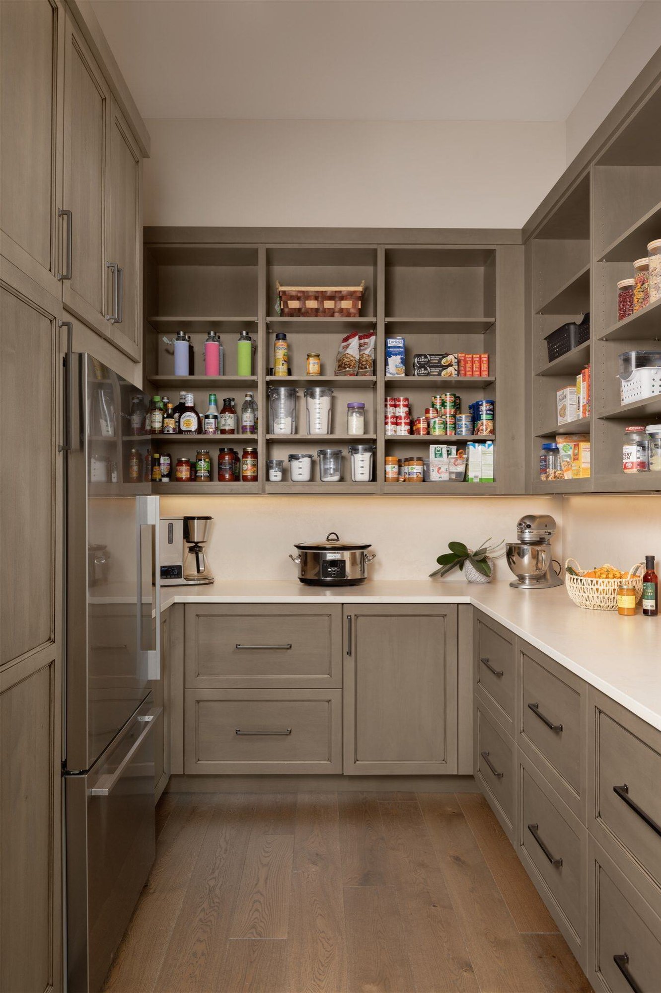 custom kitchen pantry with built in cabinets and shelving and fridge in custom built luxury boulder colorado home