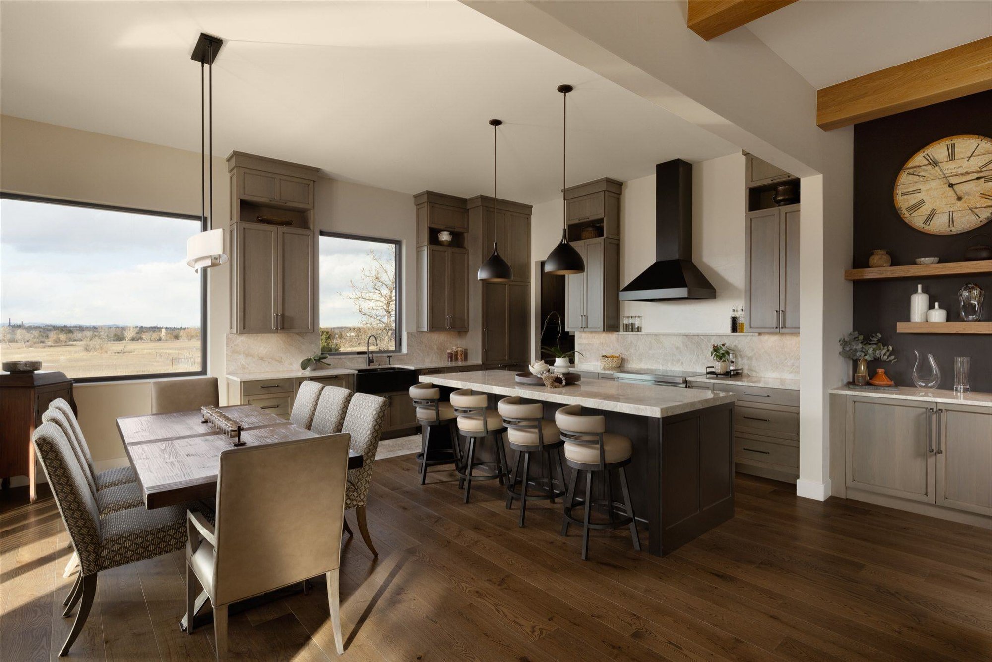 luxury kitchen with open layout, custom appliances, and dark wood floors in a custom built colorado home