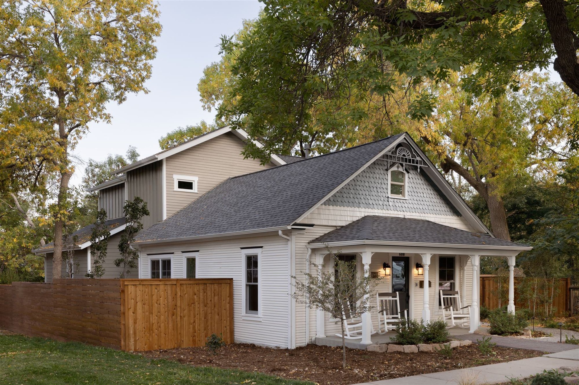 Exterior of Boulder Colorado home with covered front porch with rocking chairs
