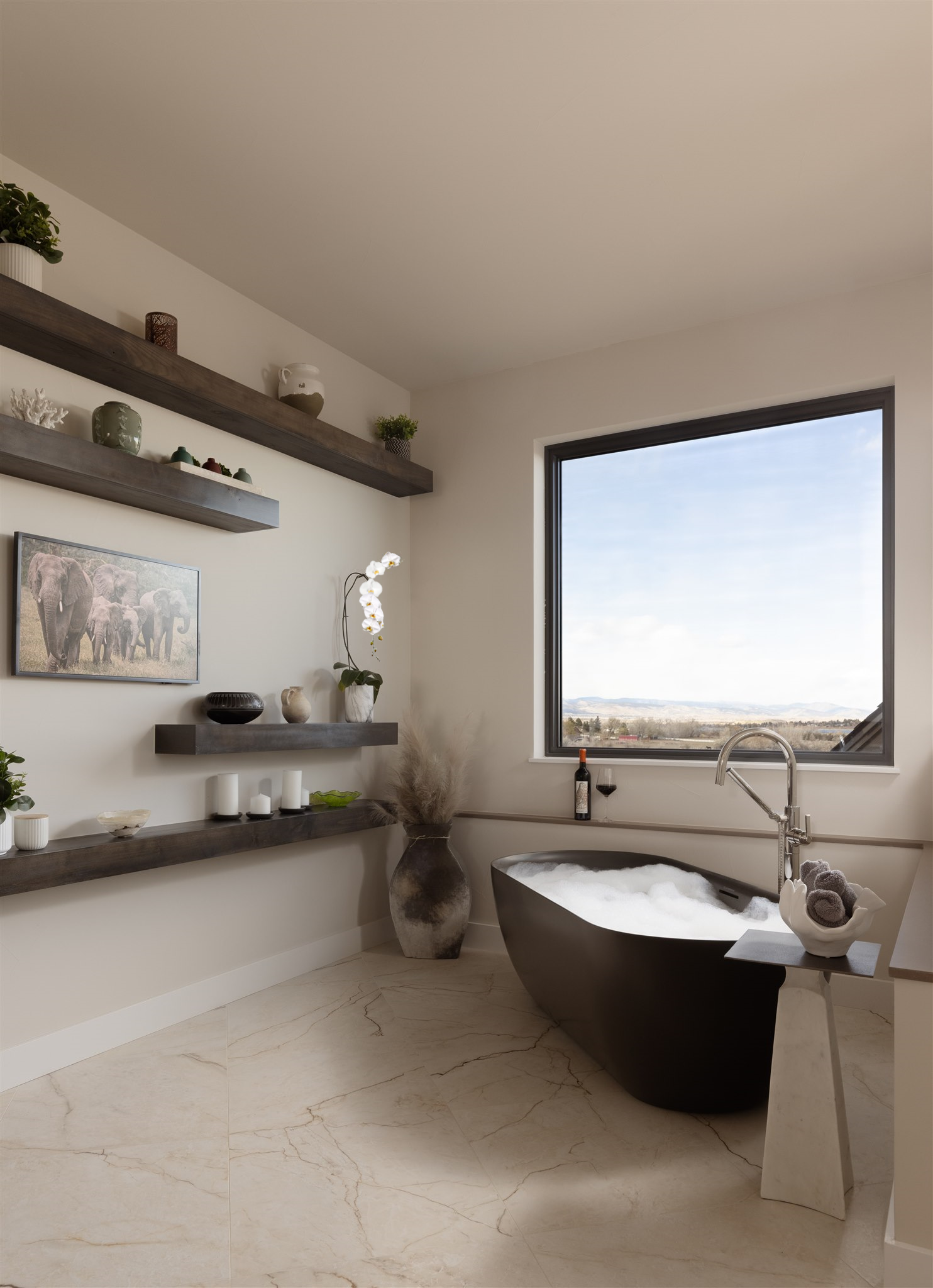soaking bathtub in the master bathroom with a view
