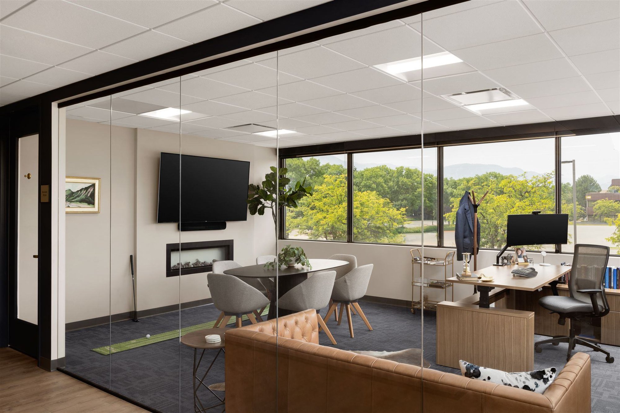 Colorado office meeting room with glass door and windows and a fireplace and television