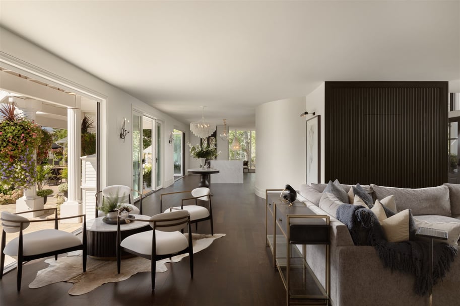 Luxury home living area with dark floors, a textured dark wall, and seating area and couch