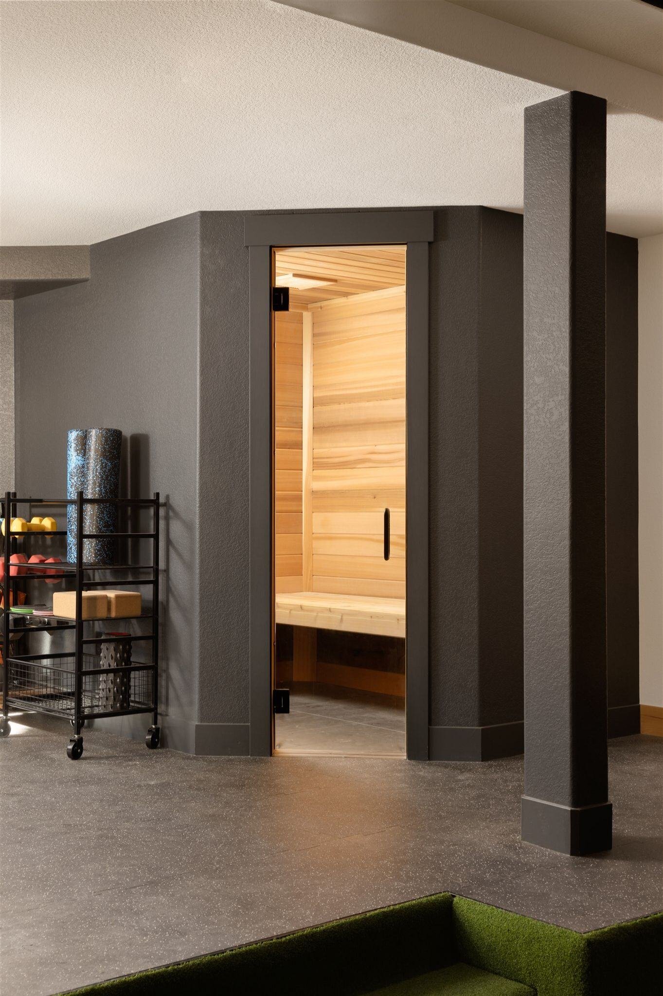 finished basement with fark gray walls and a built-in sauna room in boulder colorado