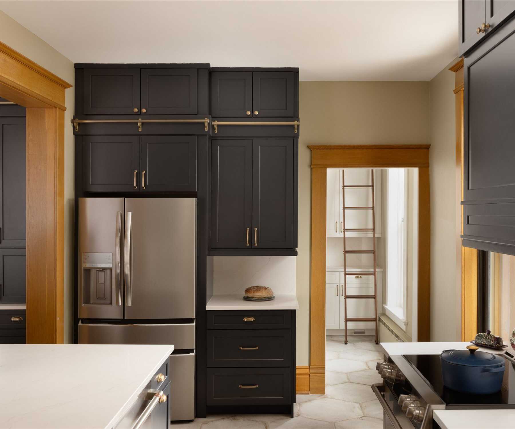 Image of custom kitchen remodel with black cabinetry and quartz counters in Old Town Longmont, CO by Petra Custom Builders