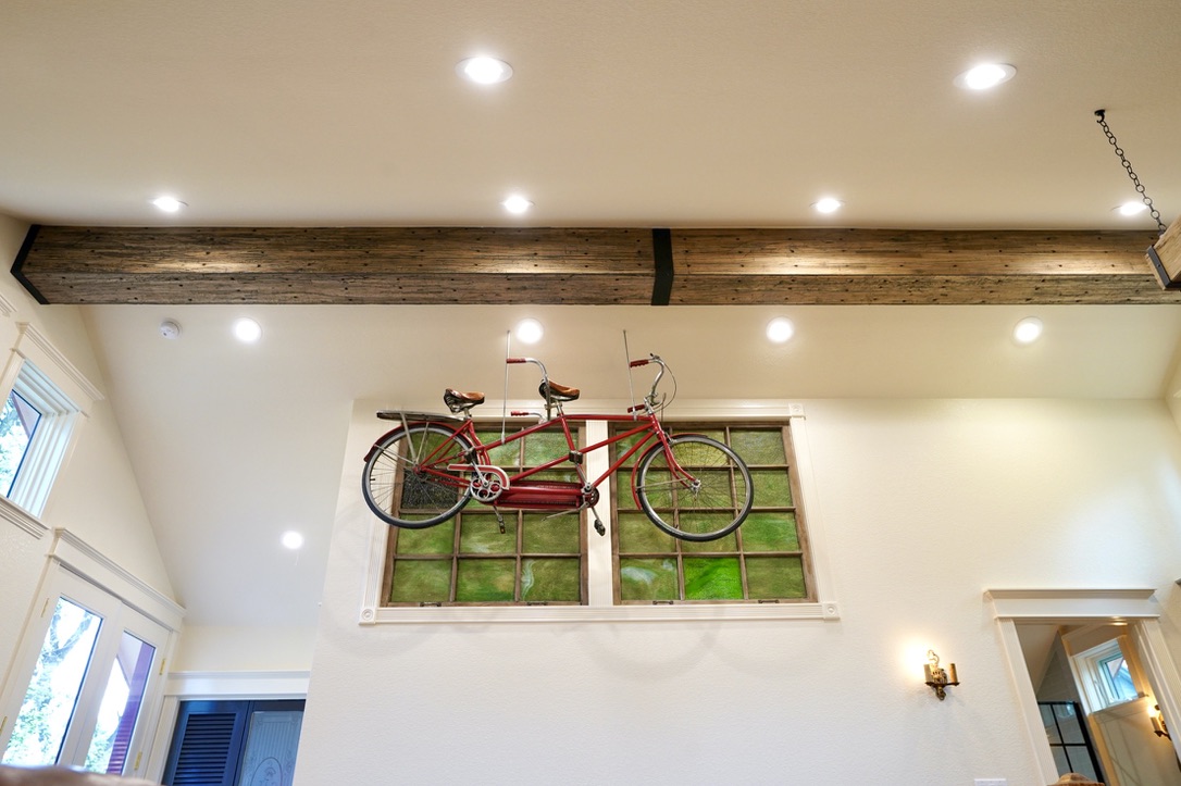 suspended antique tandem bicycle from reclaimed wooden beam 