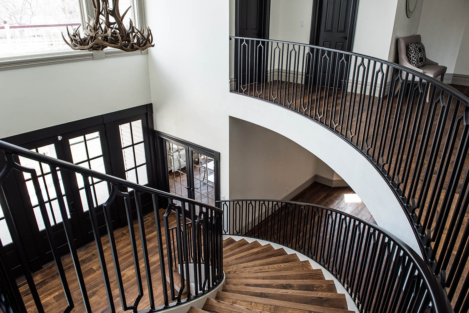 Remodeled home entryway with curved staircase