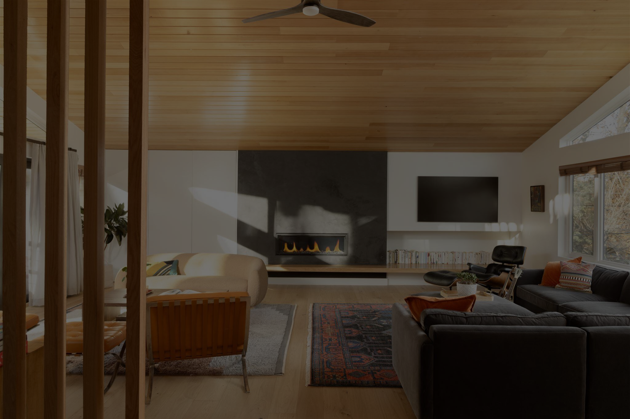 Spacious living room with slanted ceiling and natural light in a mid century modern style home remodel in boulder co