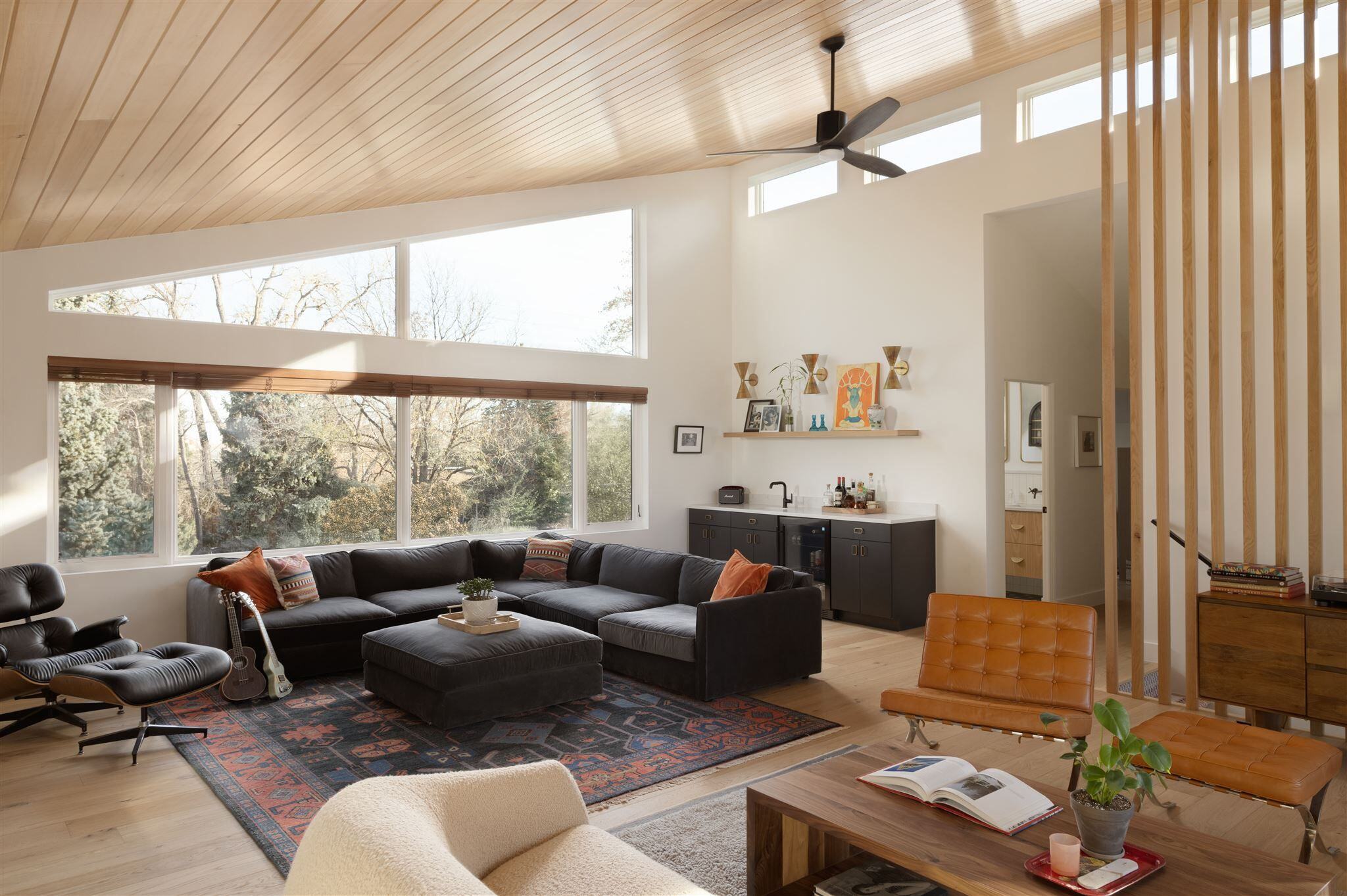 living room with slat wall and custom Venetian Plaster fireplace and T&G ceiling