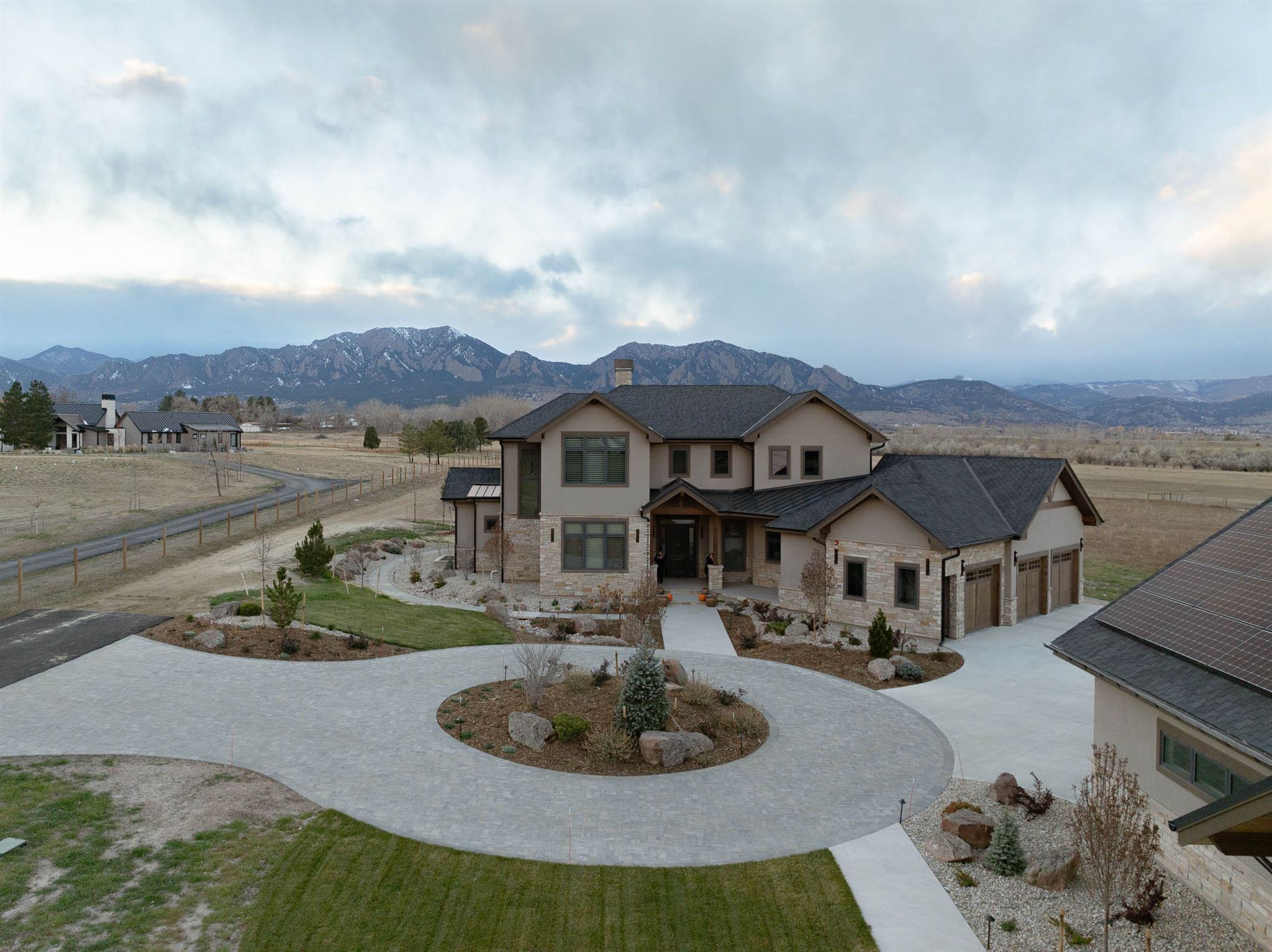 large custom built home in bounder colorado with gray driveway pavers